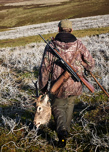 man holding deer at h5 ranch in colorado