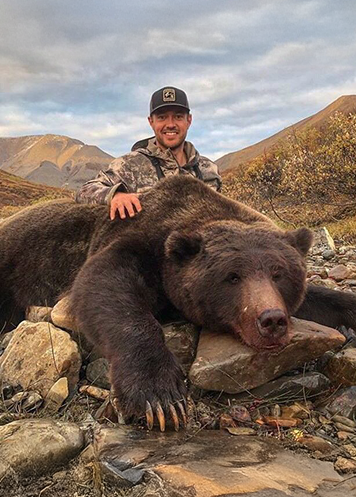man holding bear at h5 ranch in colorado